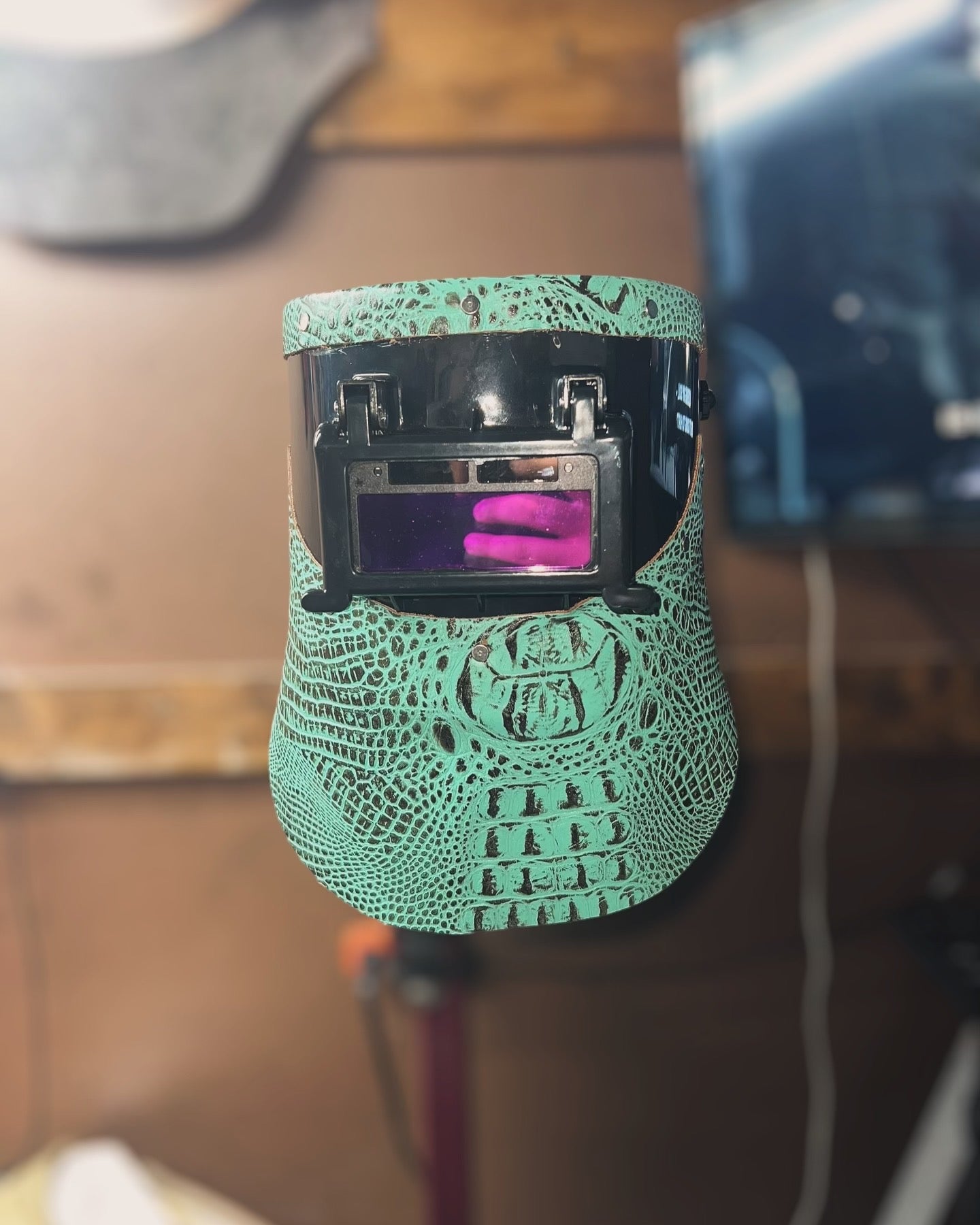 Teal alligator custom welding hood.