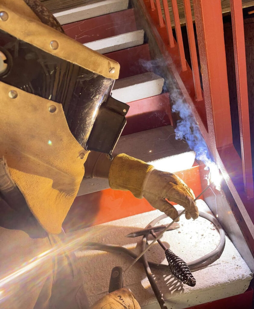 A person wearing a custom leather welding gear.