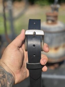 Client viewing the handmade leather work belts catalog.