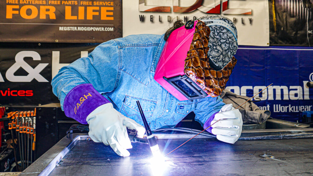 A person wearing a custom square hood for welding.